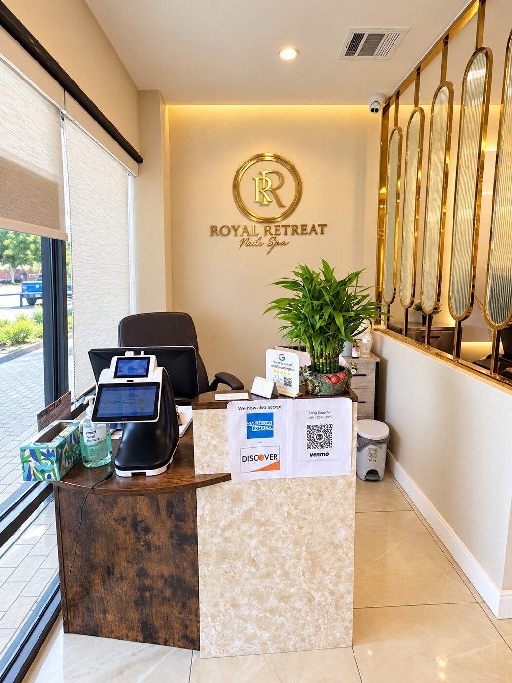 The Royal Retreat Pedispa front desk, with the gold monogram on the wall